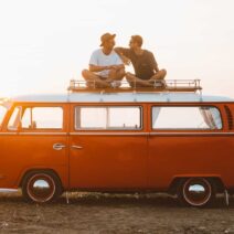Two men sitting on RV campervan