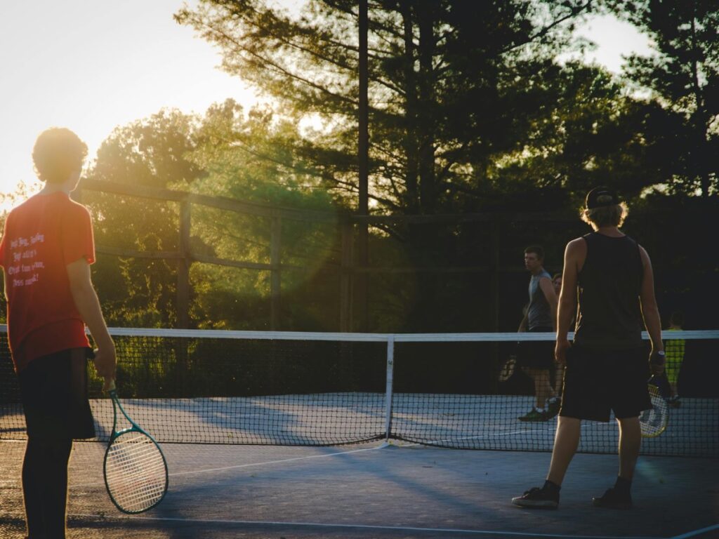 Friends playing tennis on a tennis court